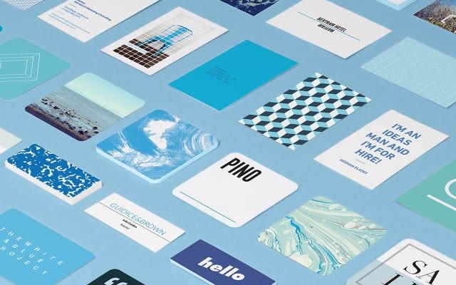 Mosaic of standard Business Cards in various sizes, shapes and designs on blue background.